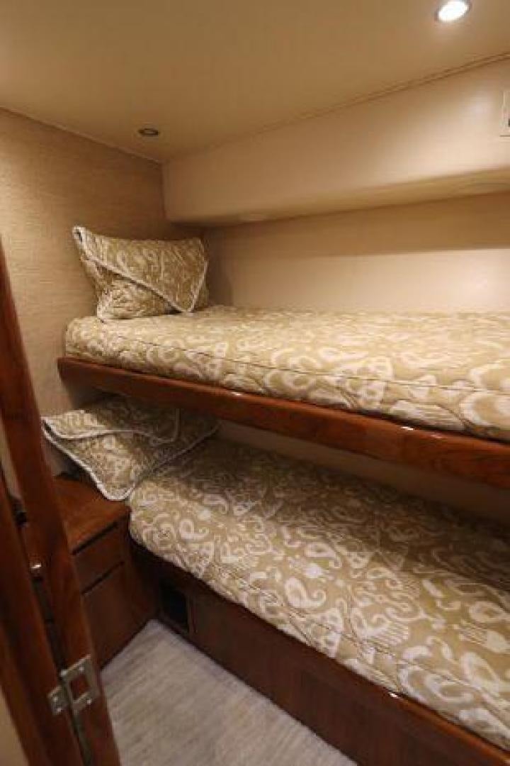 a bed with a wooden frame aboard GABEA Yacht for Sale