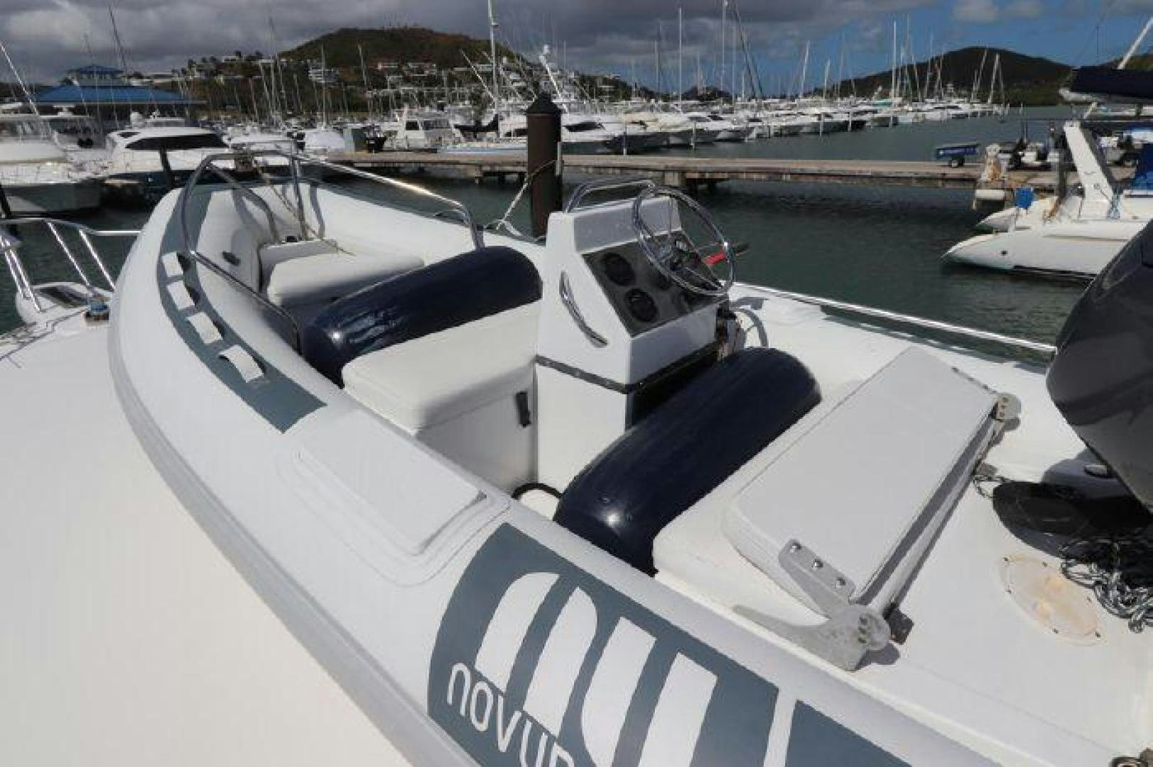 a white boat in a harbor aboard GABEA Yacht for Sale