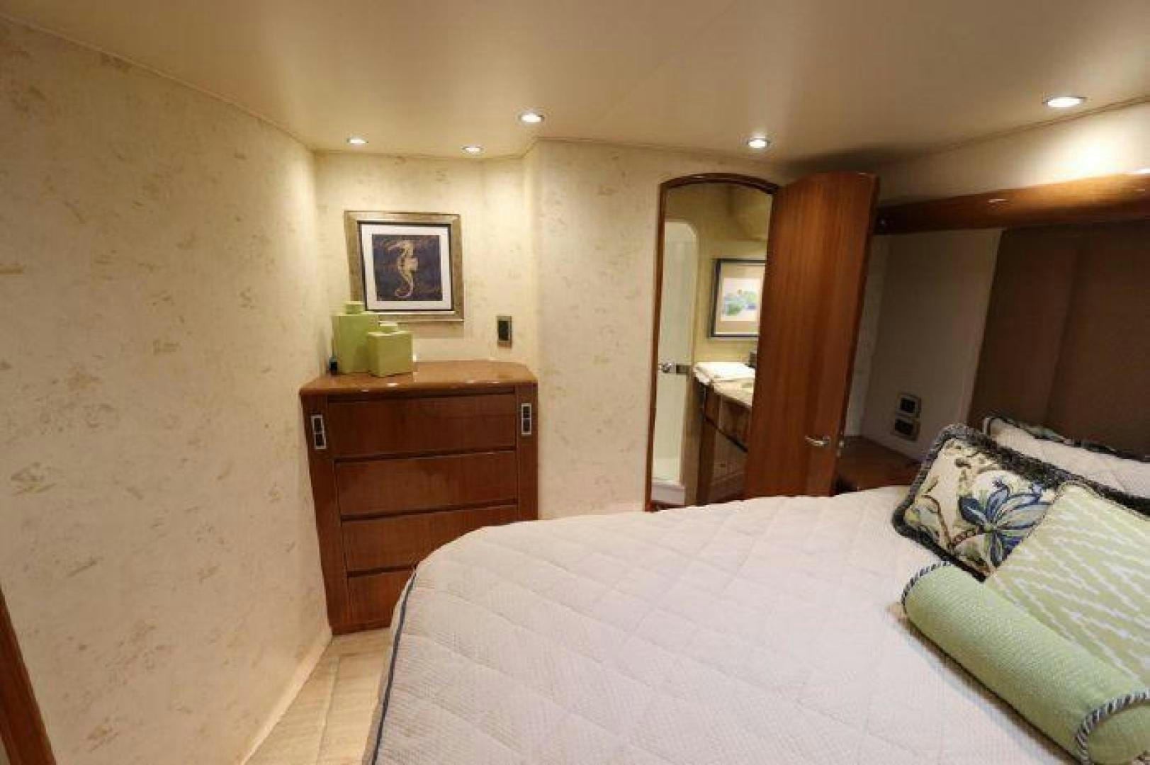 a bedroom with a bed and a dresser aboard GABEA Yacht for Sale