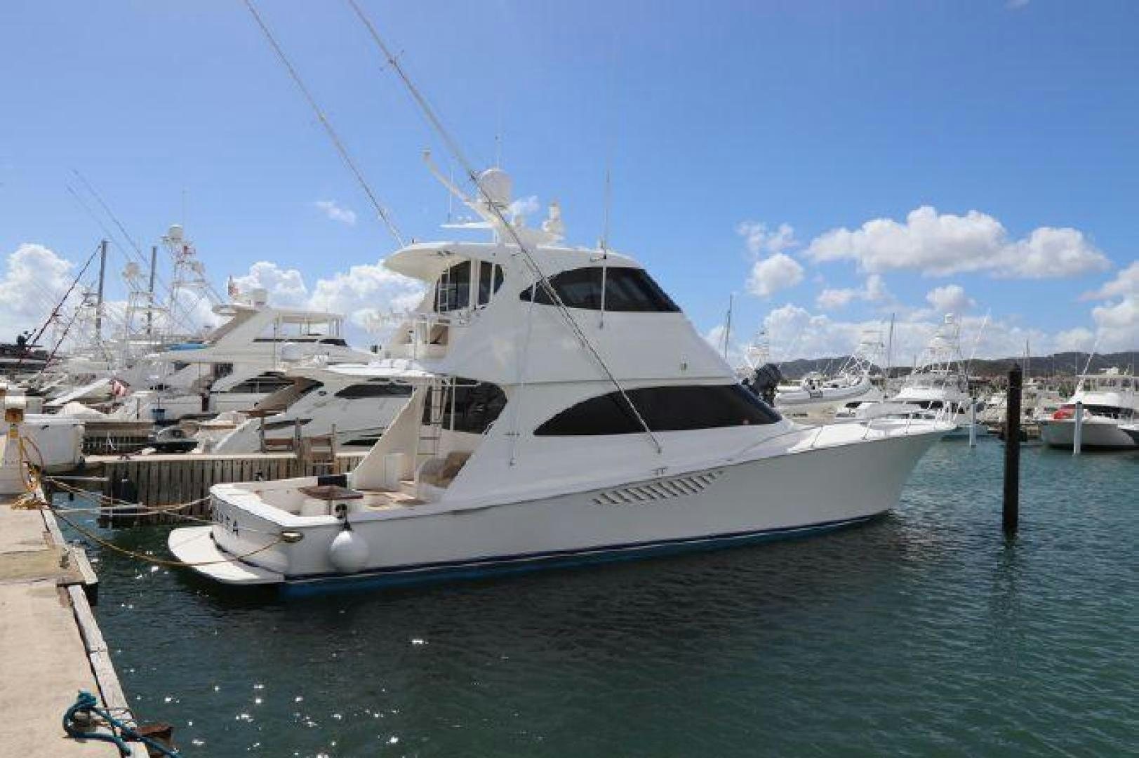 a white yacht docked at a pier aboard GABEA Yacht for Sale