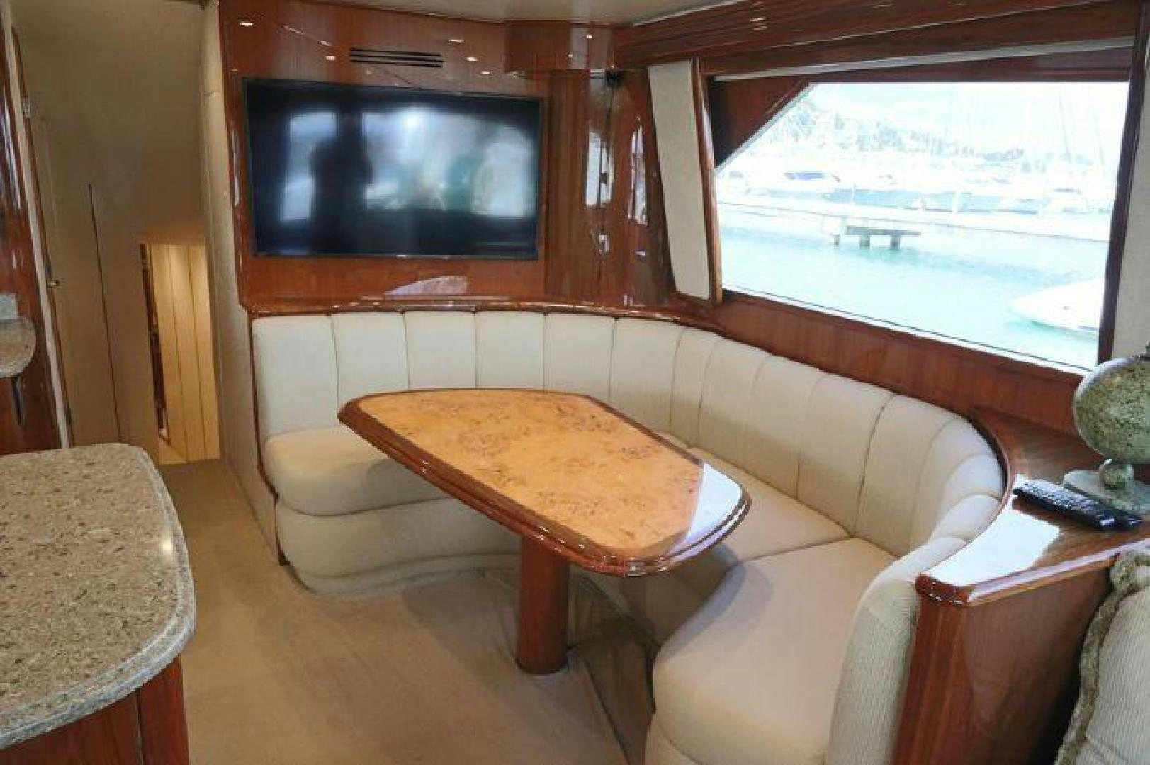 a living room with a table and a tv aboard GABEA Yacht for Sale