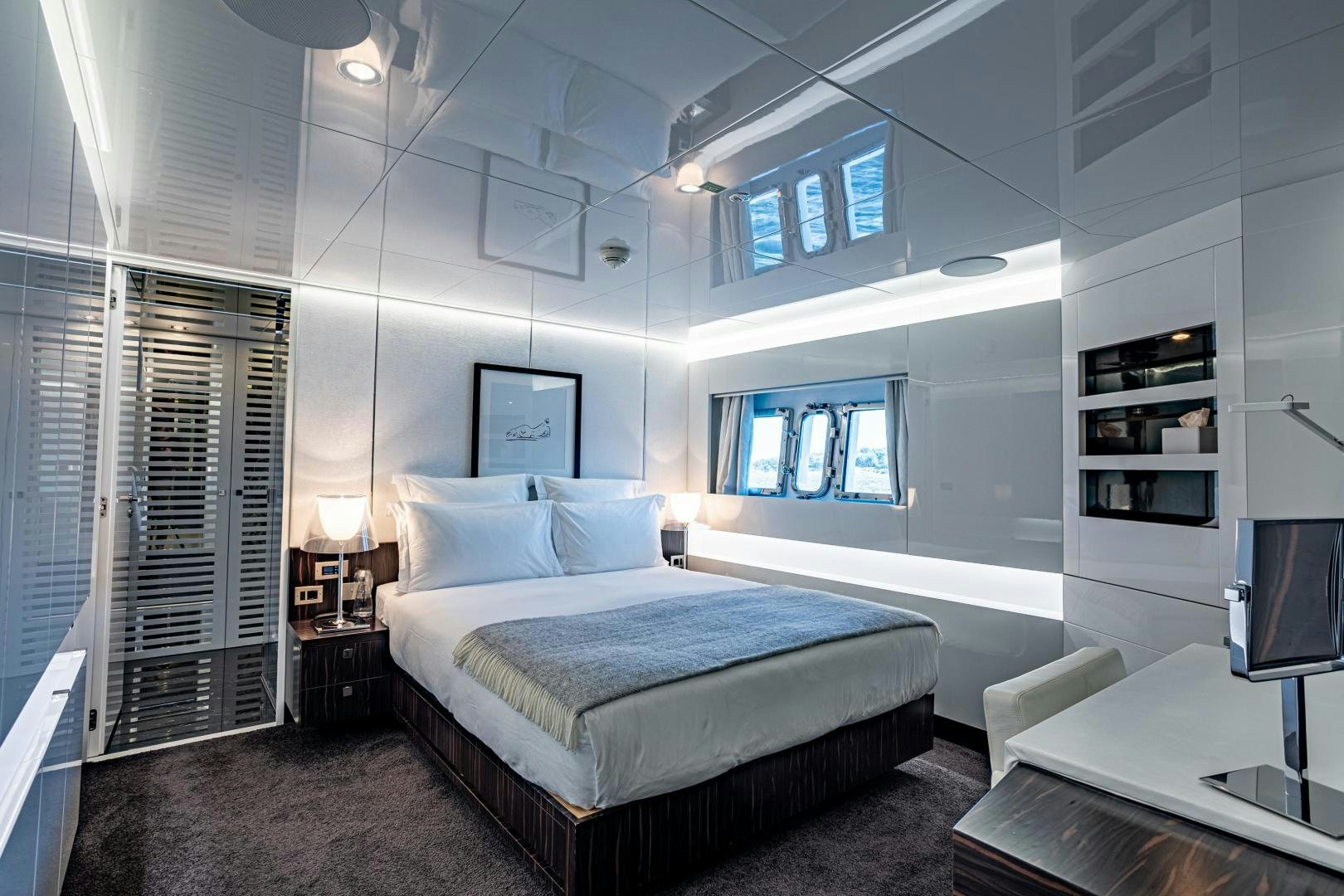 a room with a bed and a desk aboard M Yacht for Sale