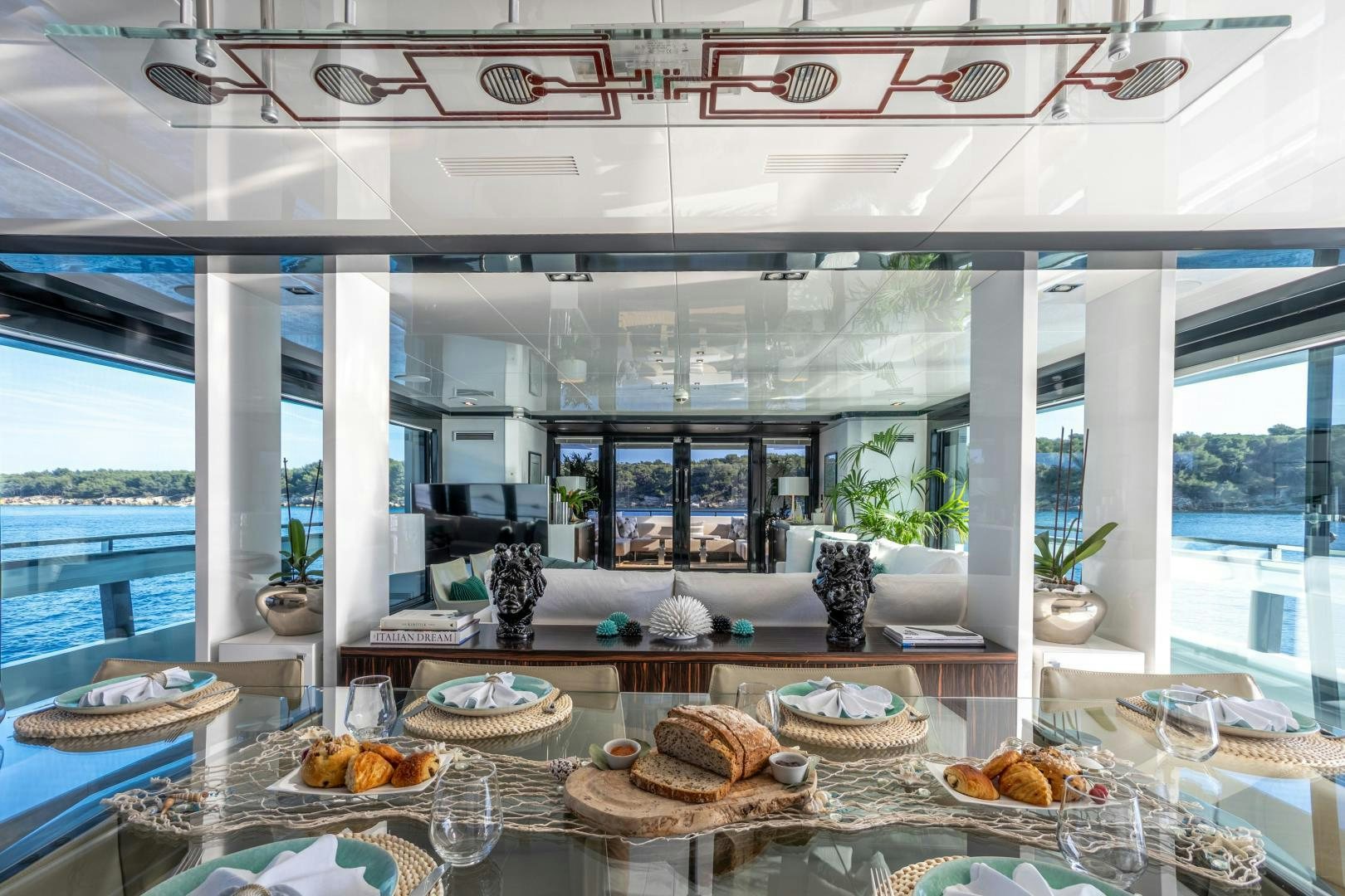 a table with food and plates aboard M Yacht for Sale
