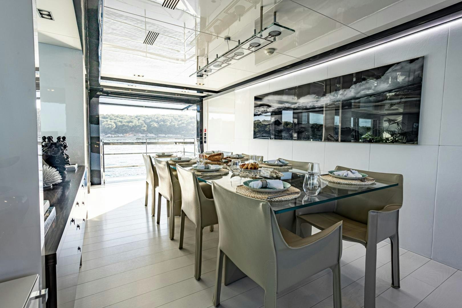 a dining table in a room aboard M Yacht for Sale