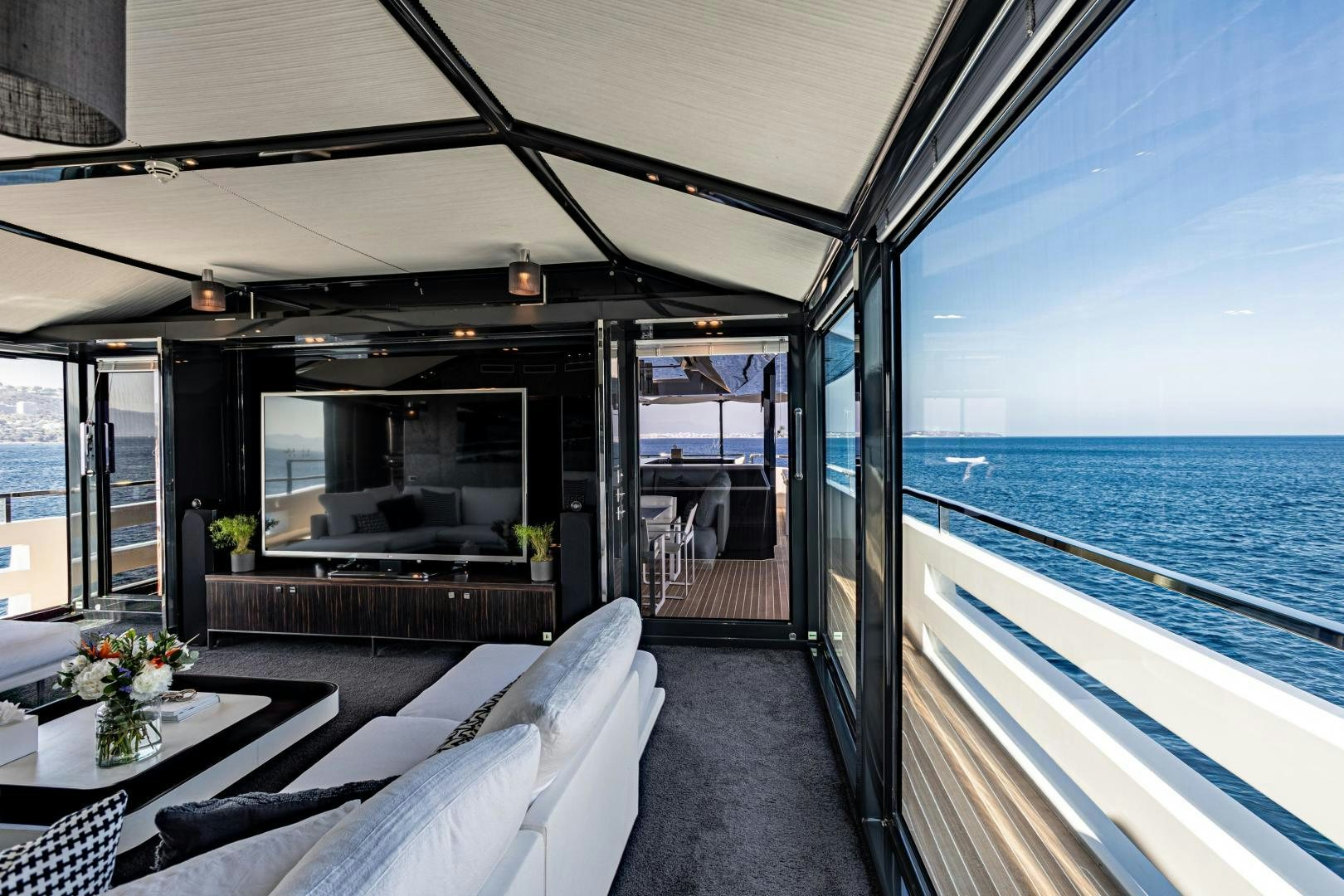 a boat with a table and chairs on the deck aboard M Yacht for Sale