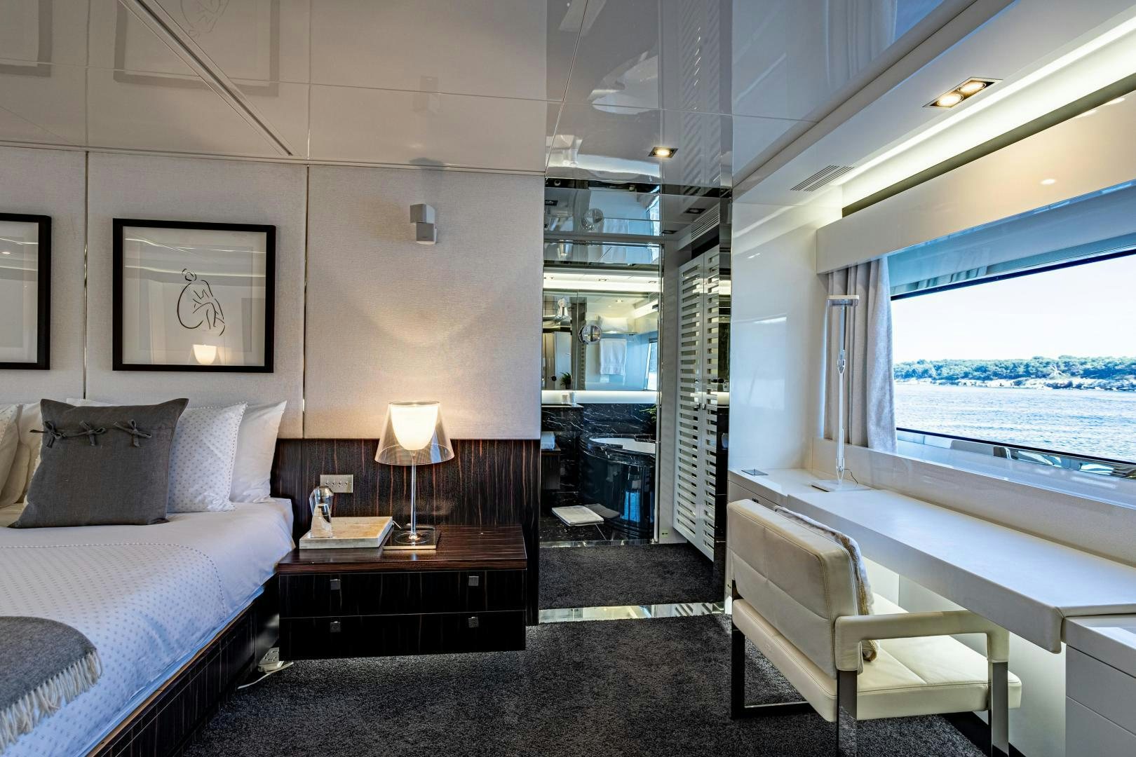 a bedroom with a bed and a window aboard M Yacht for Sale