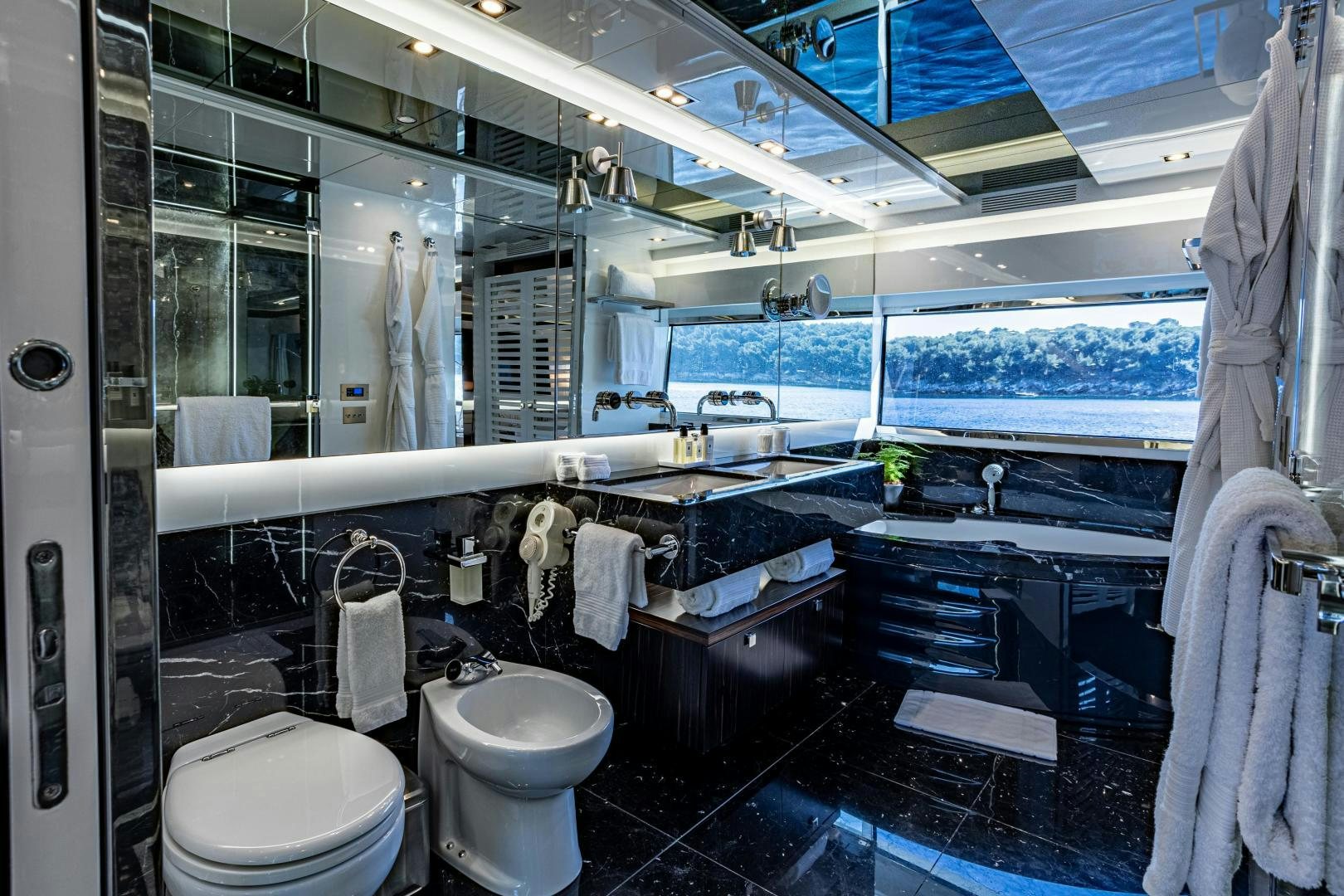 a bathroom with a large mirror aboard M Yacht for Sale