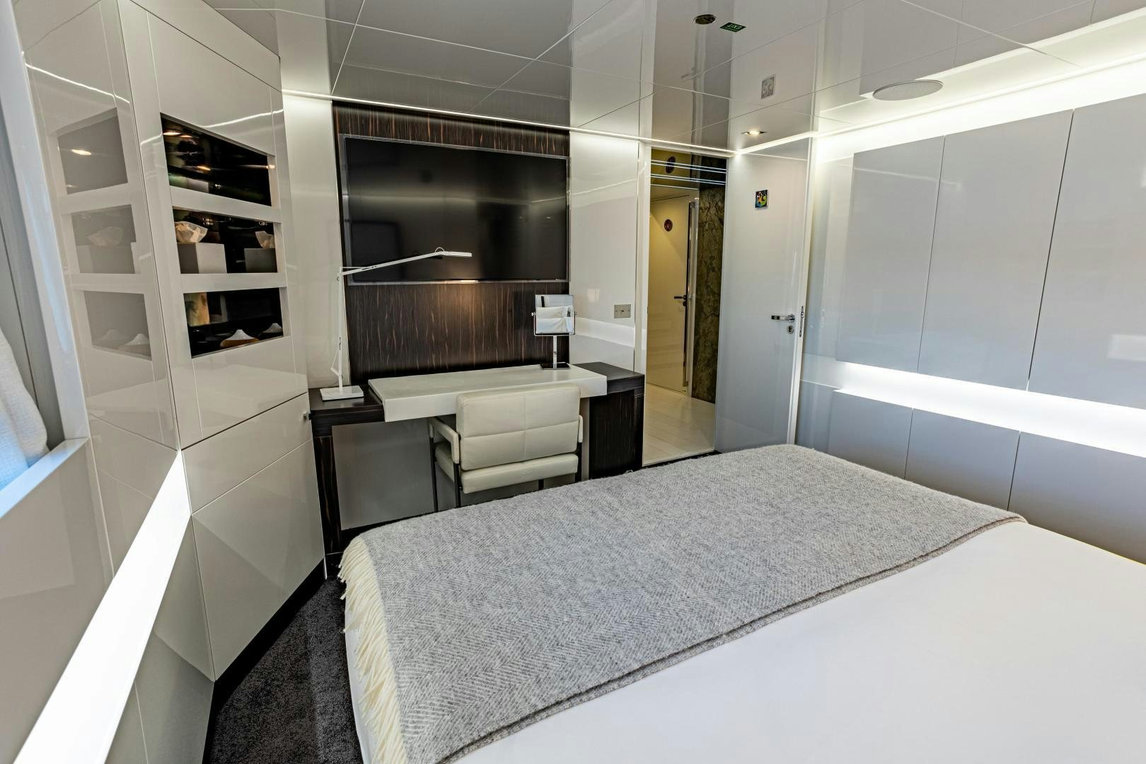 a room with a bed and a desk aboard M Yacht for Sale