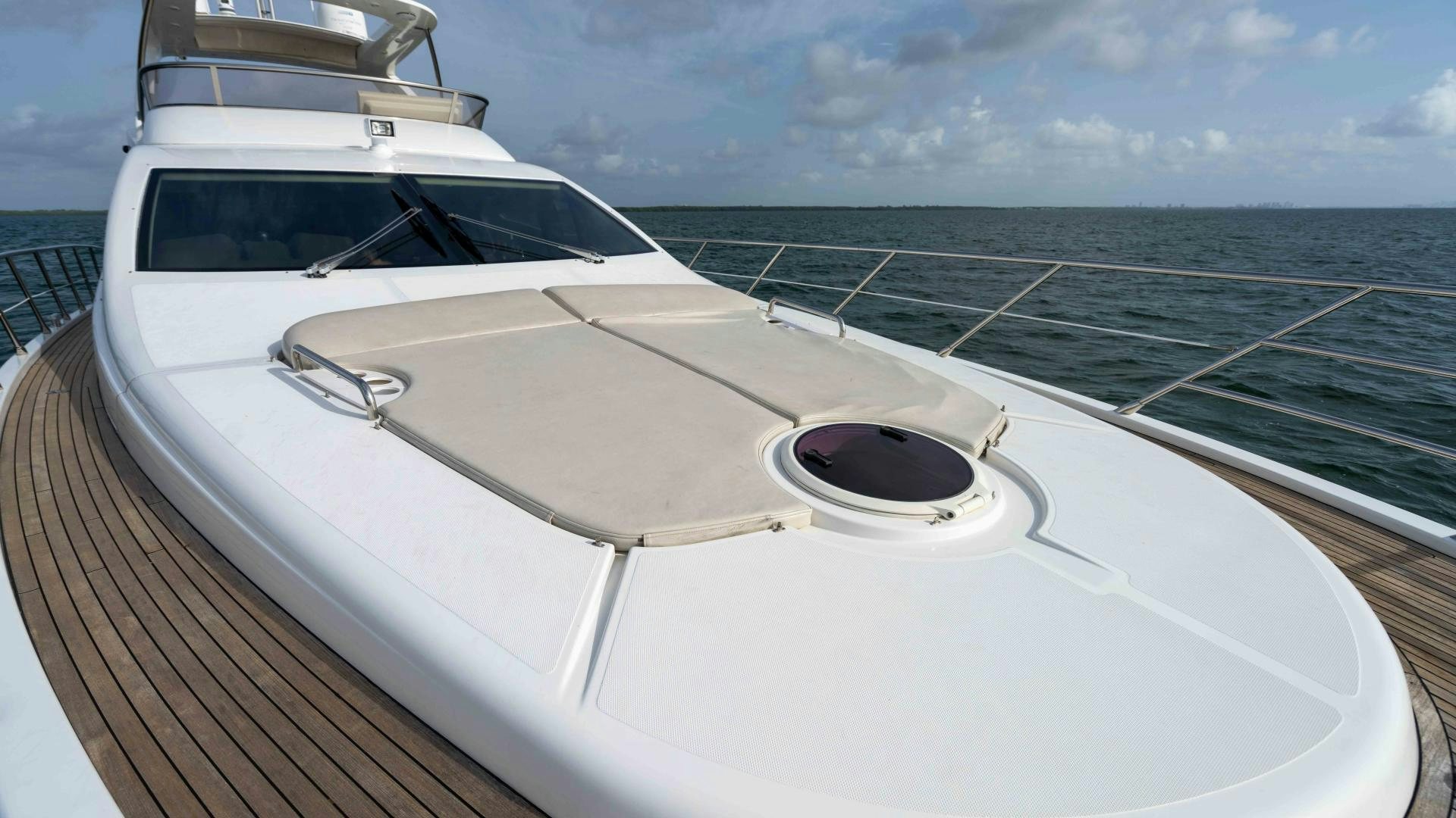 a white yacht on a deck aboard 4-PLAY Yacht for Sale