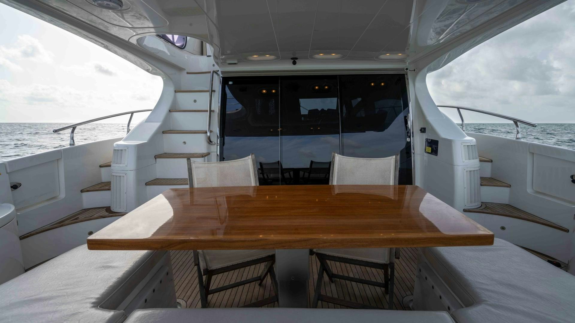 a table with chairs on it aboard 4-PLAY Yacht for Sale