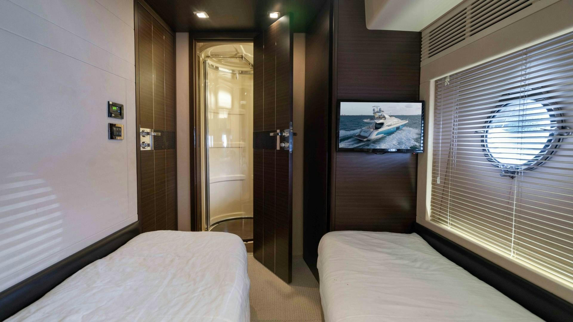 a room with a bed and a television aboard 4-PLAY Yacht for Sale