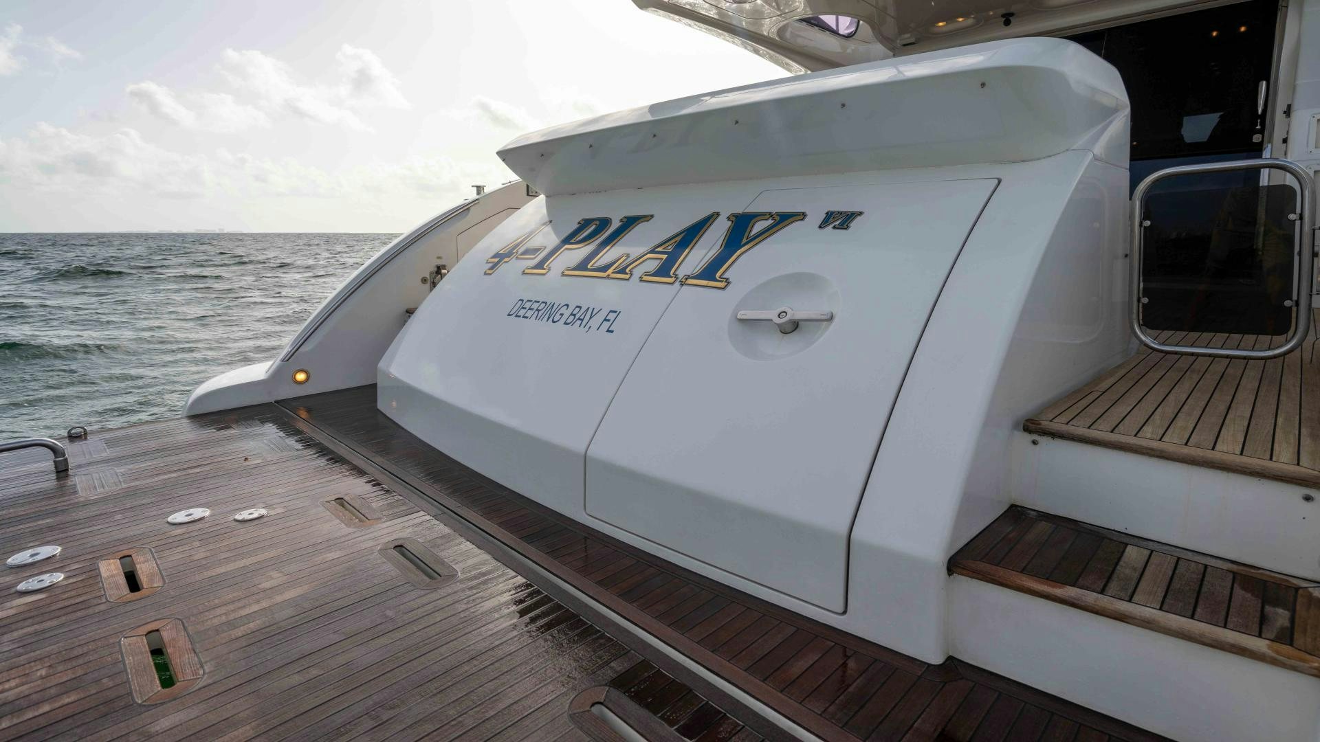 a white boat on a dock aboard 4-PLAY Yacht for Sale