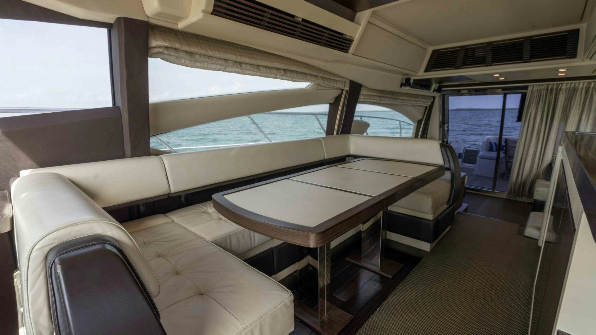 a room with a table and chairs aboard 4-PLAY Yacht for Sale