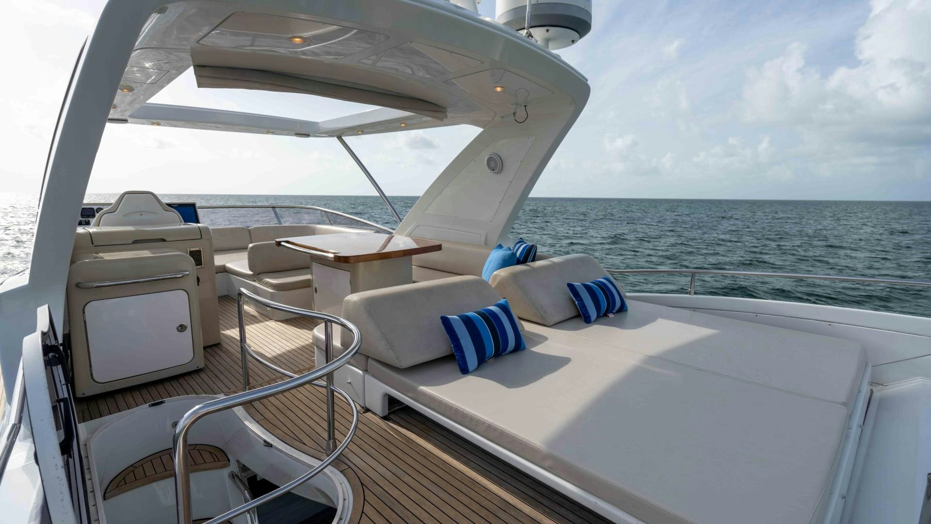 a boat with a white table and chairs on it aboard 4-PLAY Yacht for Sale