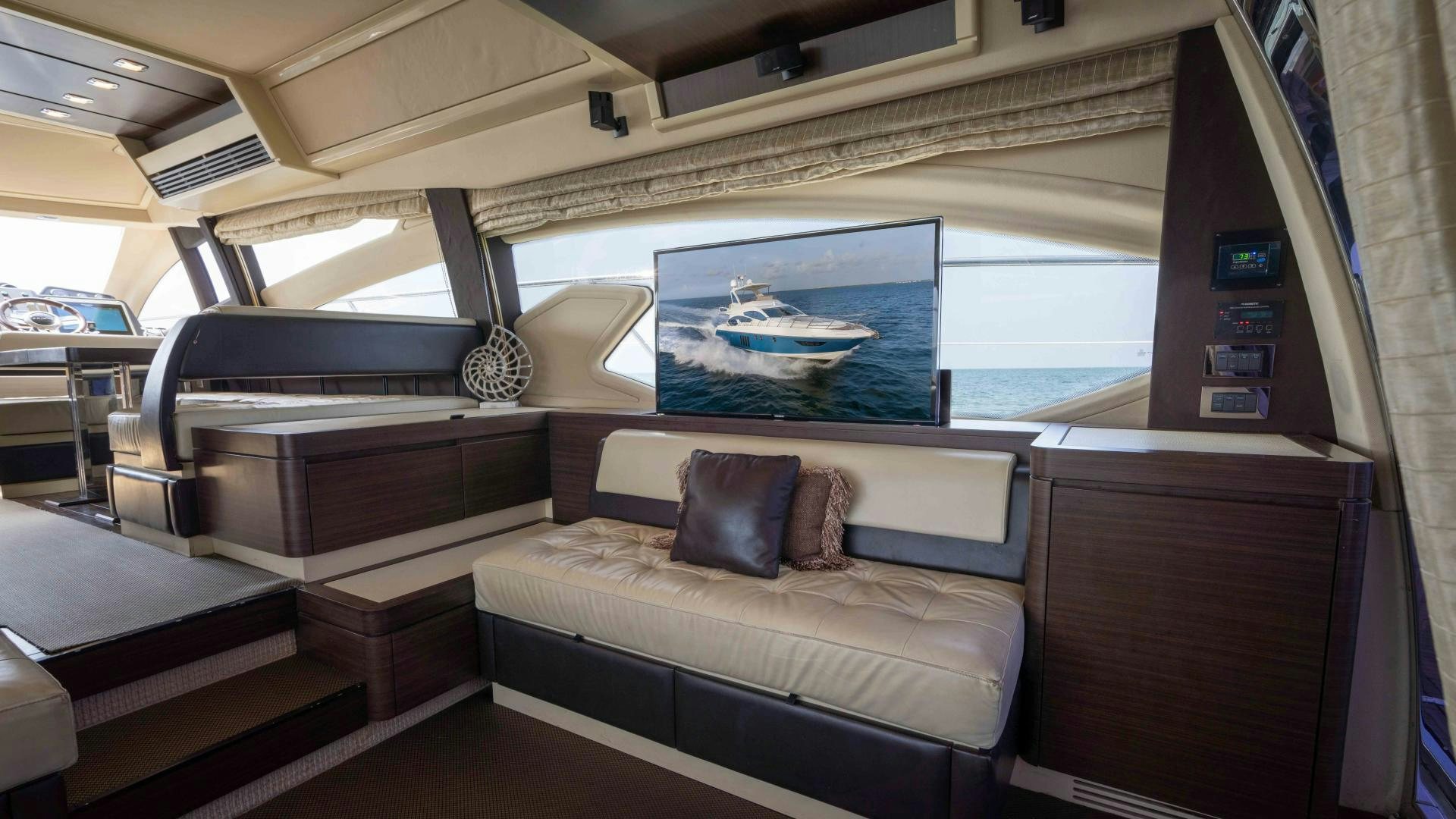 a room with a couch and a television aboard 4-PLAY Yacht for Sale