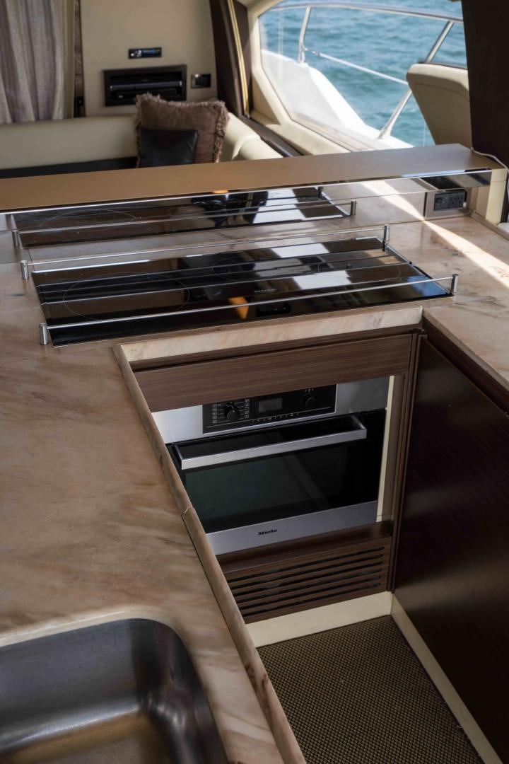 a table with a microwave on it aboard 4-PLAY Yacht for Sale