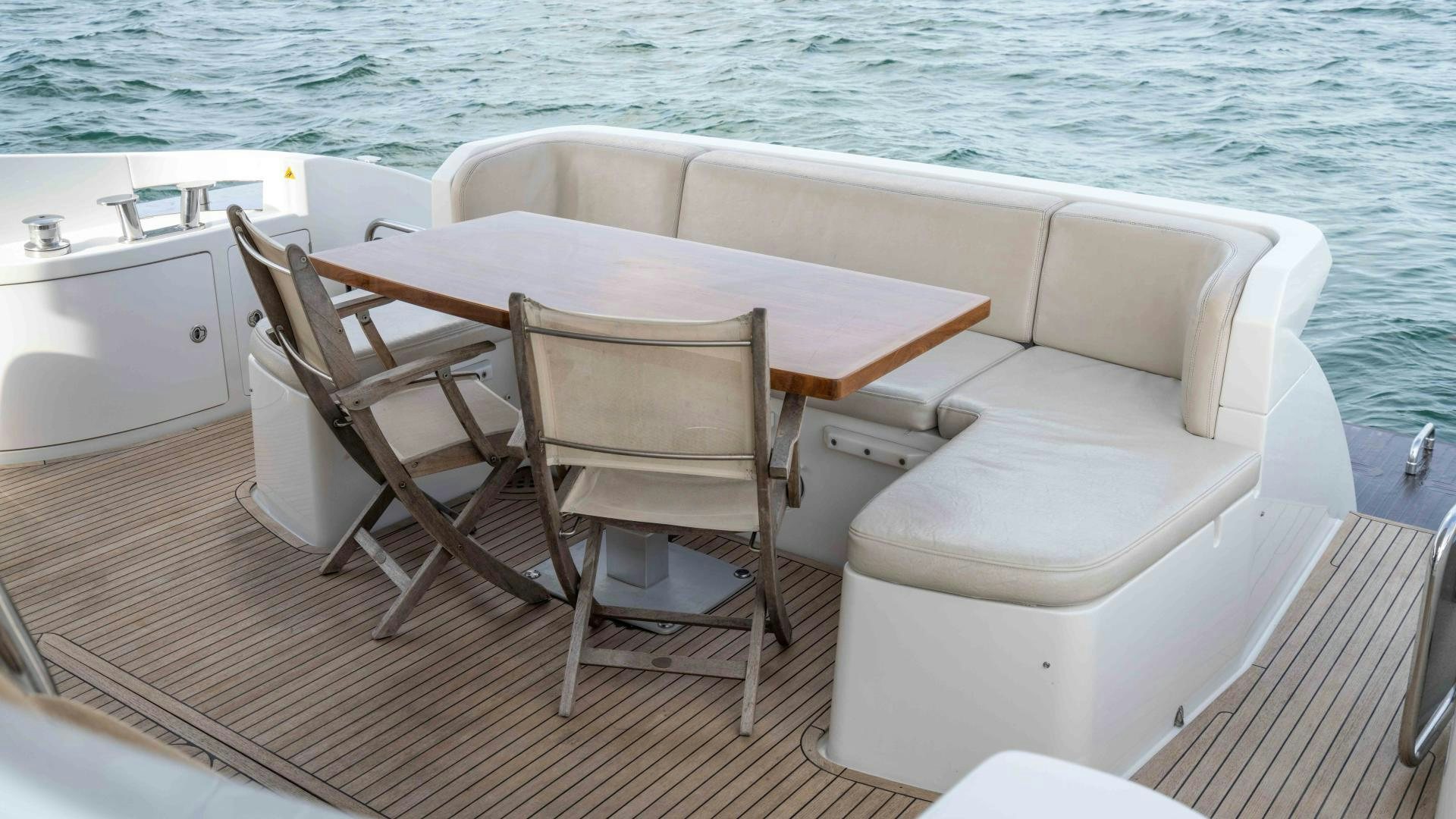 a table and chairs on a boat aboard 4-PLAY Yacht for Sale