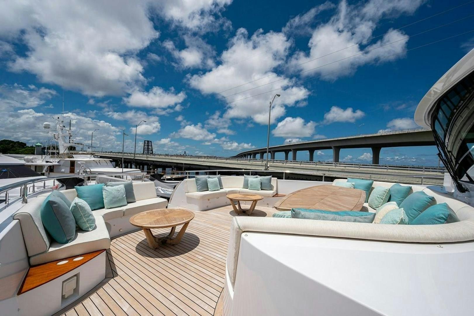 a deck with a table and chairs on it aboard CHECKED OUT Yacht for Sale
