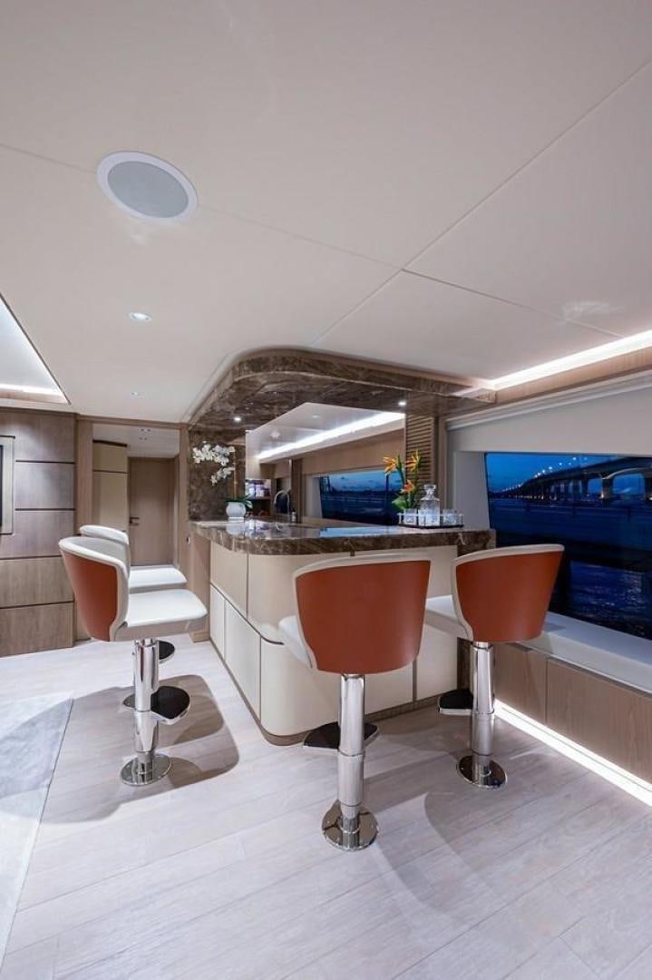 a room with a table chairs and a counter with a sink aboard CHECKED OUT Yacht for Sale