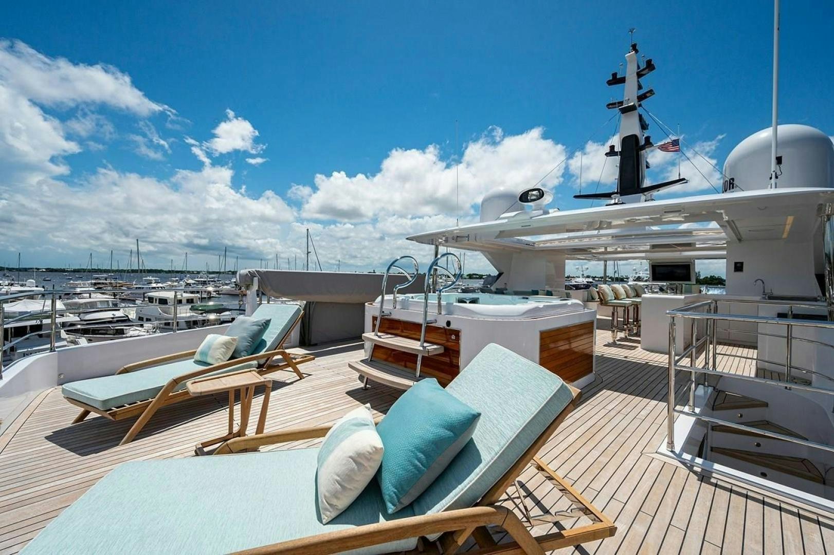 a deck with a large ship in the water aboard CHECKED OUT Yacht for Sale
