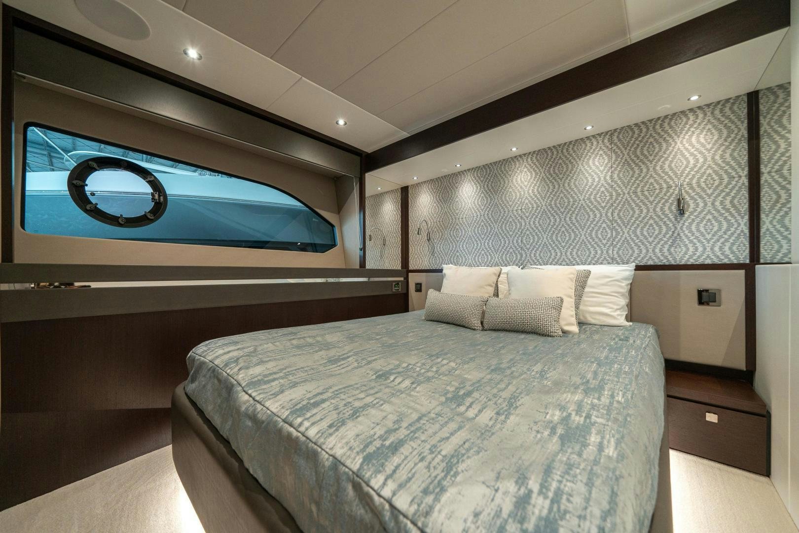 a bed with a blue screen aboard ONE Yacht for Sale