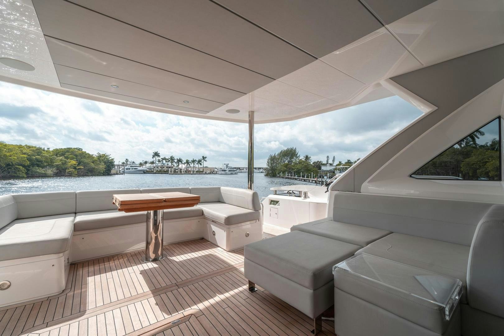 a room with a table and couches aboard ONE Yacht for Sale