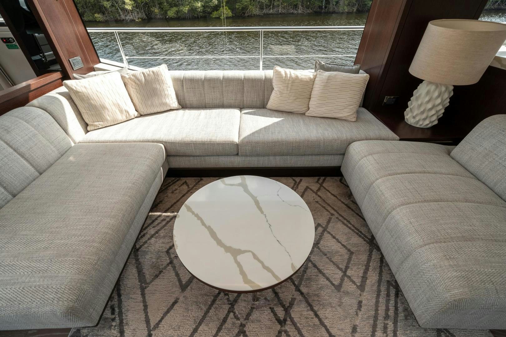 a couch and a table in a room aboard ONE Yacht for Sale