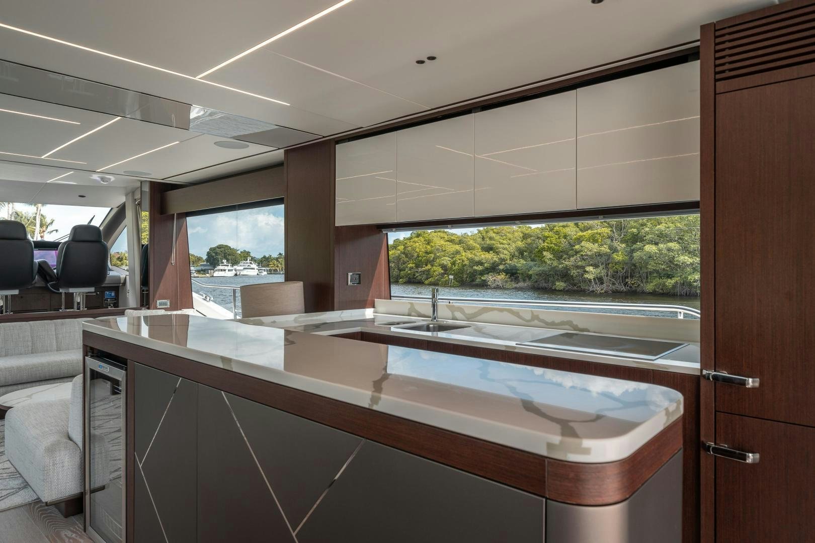 a room with a large window and a table with chairs and a window aboard ONE Yacht for Sale