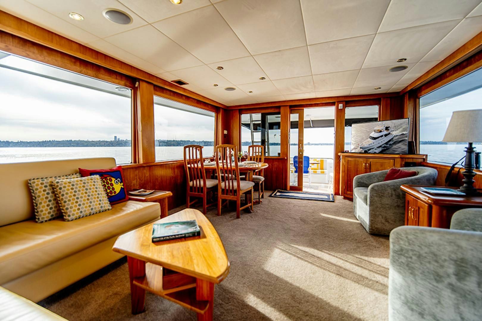 a living room with a couch and a table aboard the happy boat Yacht for Sale