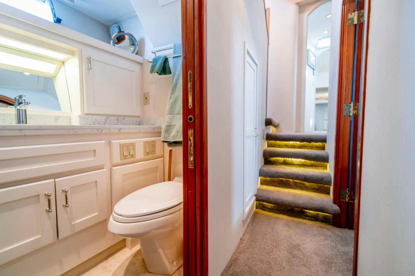 a bathroom with a toilet and a sink aboard the happy boat Yacht for Sale