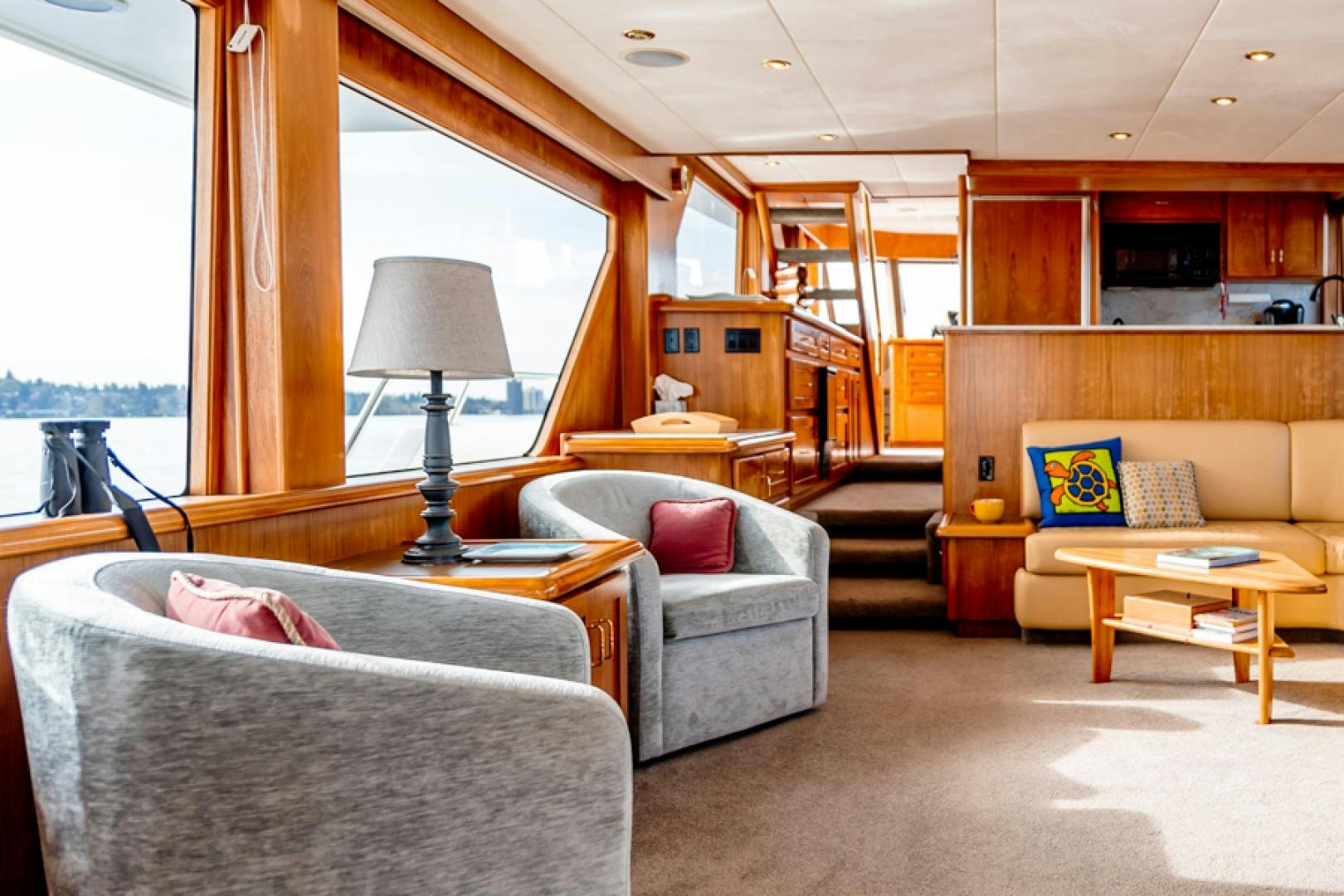 a living room with a couch and a table aboard the happy boat Yacht for Sale