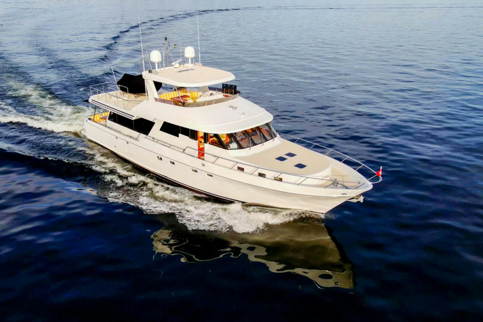 a white boat on the water aboard the happy boat Yacht for Sale