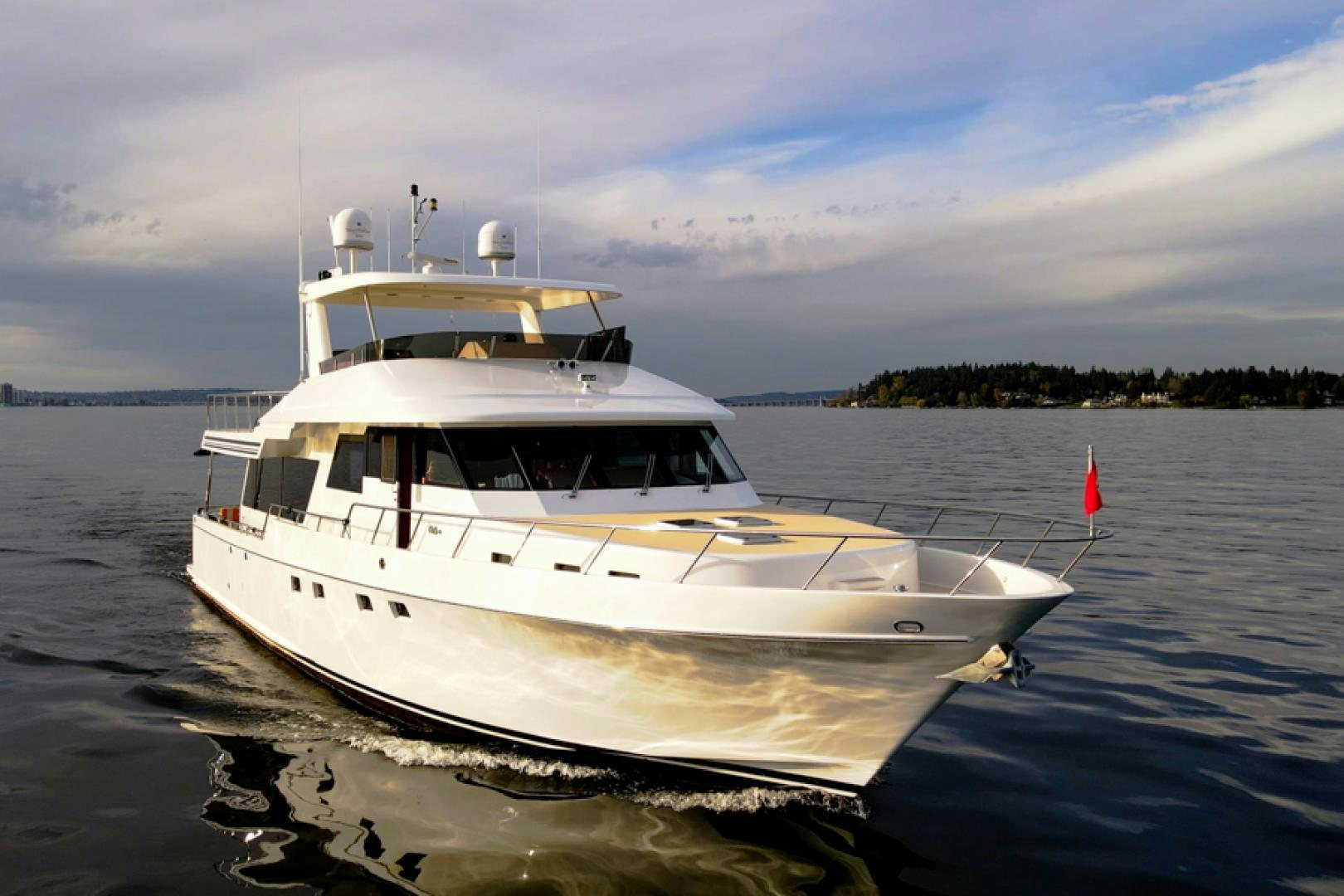 a white boat on the water aboard the happy boat Yacht for Sale