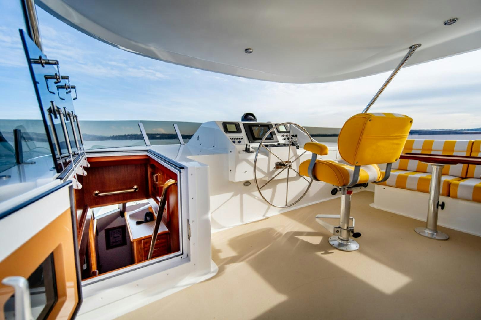 a yellow chair in a room aboard the happy boat Yacht for Sale
