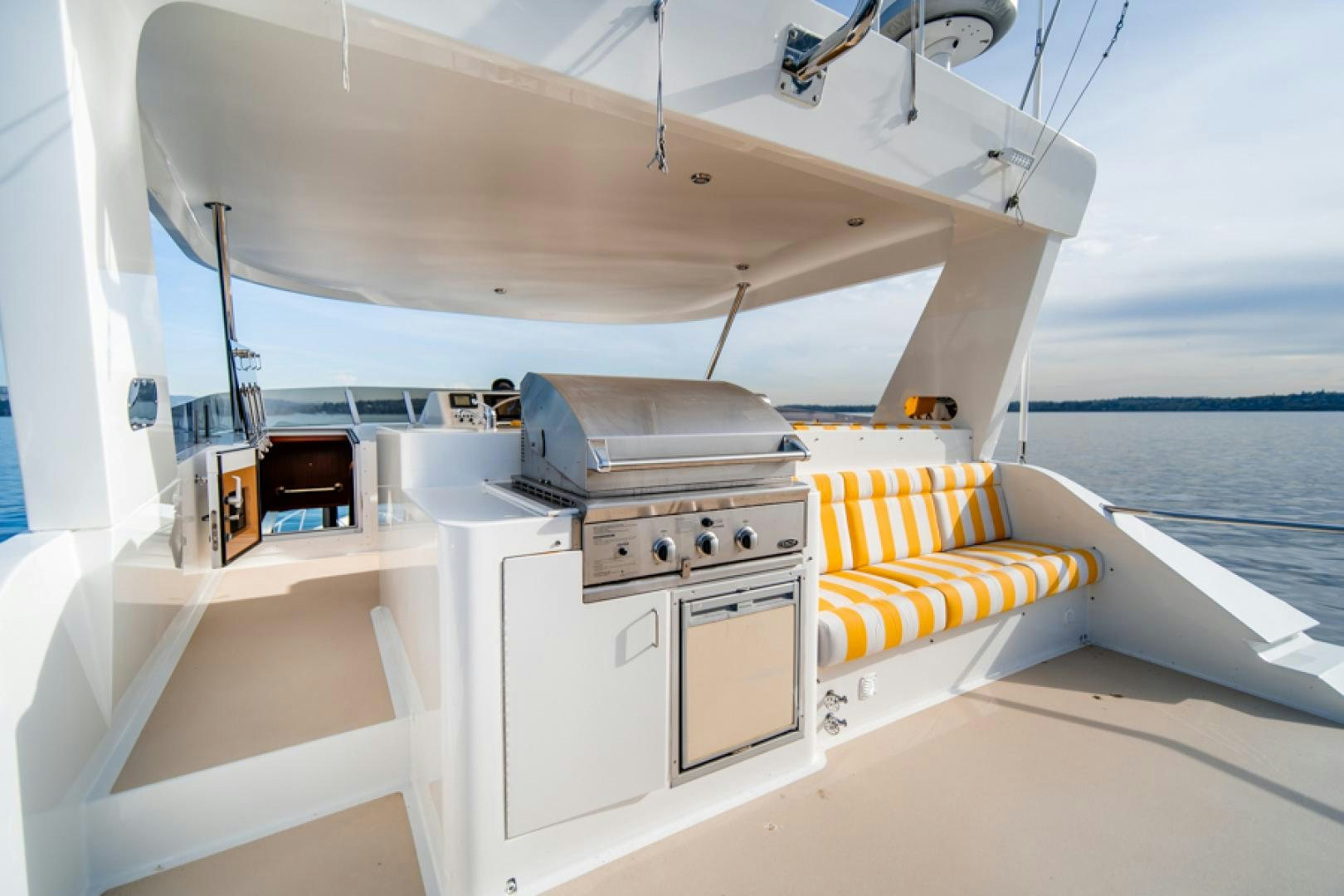 a boat with a bed and a couch aboard the happy boat Yacht for Sale