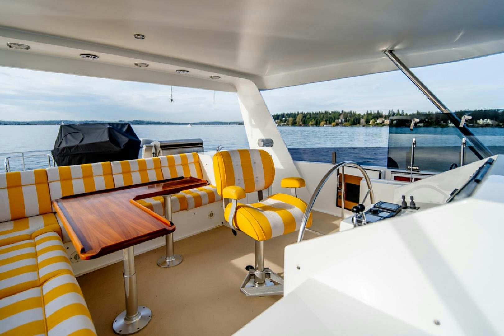 a boat with a deck and chairs aboard the happy boat Yacht for Sale