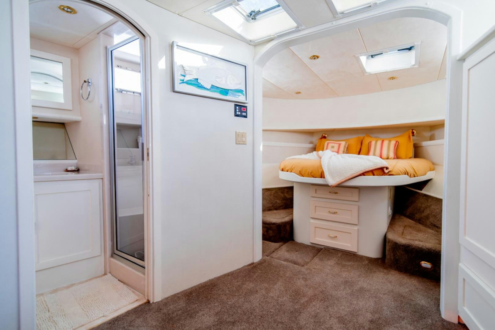 a room with a bed and a couch aboard the happy boat Yacht for Sale