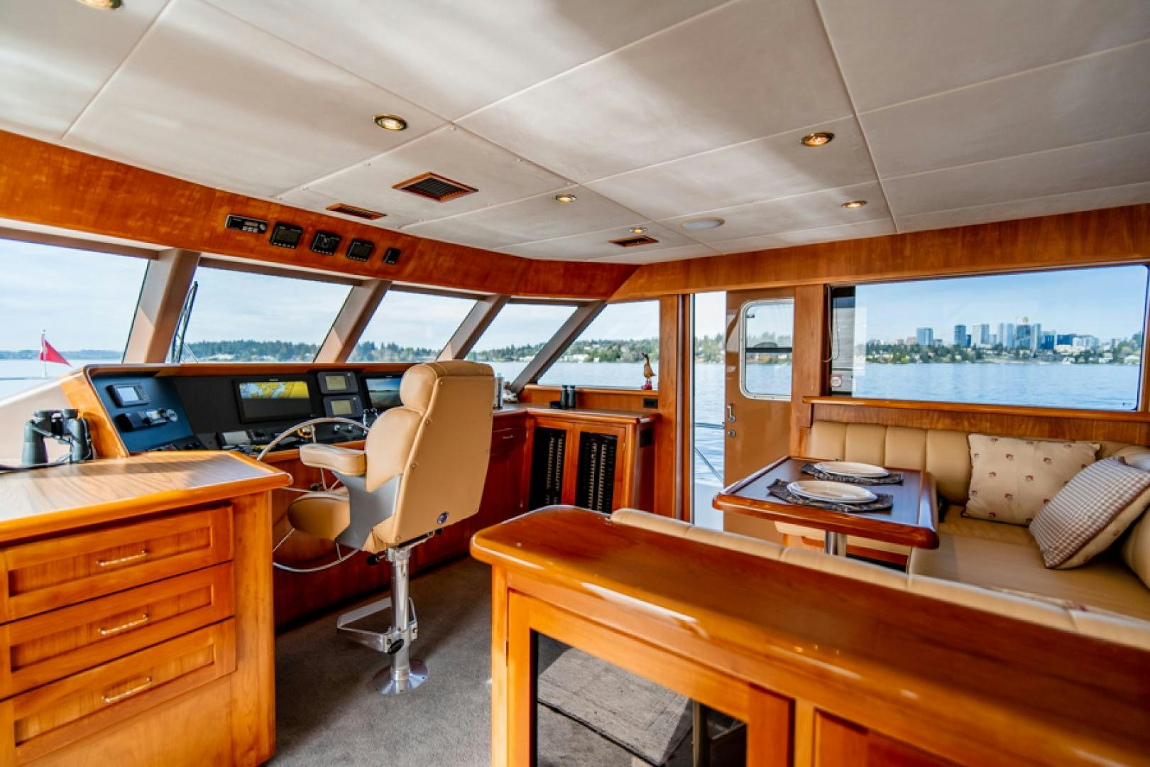 a room with a desk and a bed aboard the happy boat Yacht for Sale