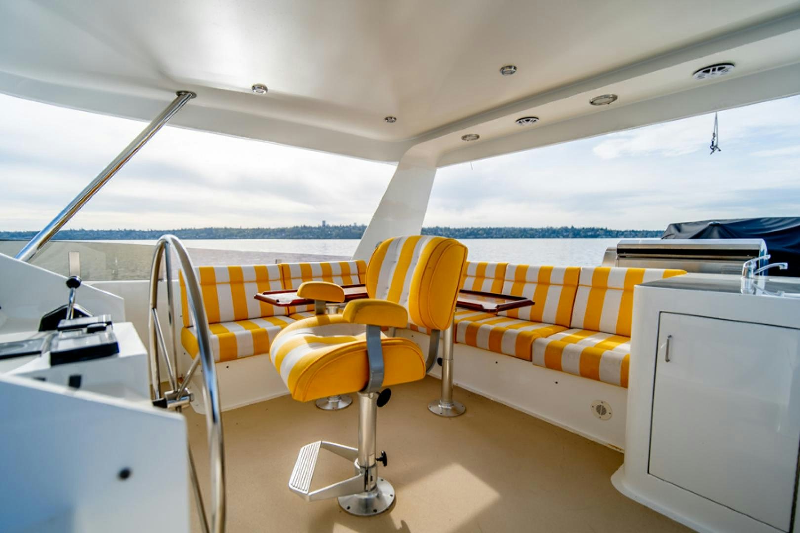 a boat with chairs and a desk aboard the happy boat Yacht for Sale