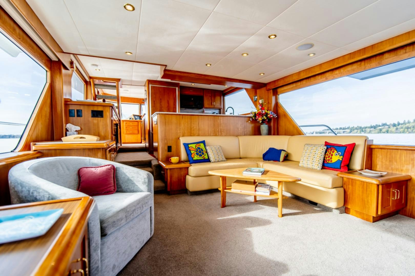 a living room with a couch and a table aboard the happy boat Yacht for Sale