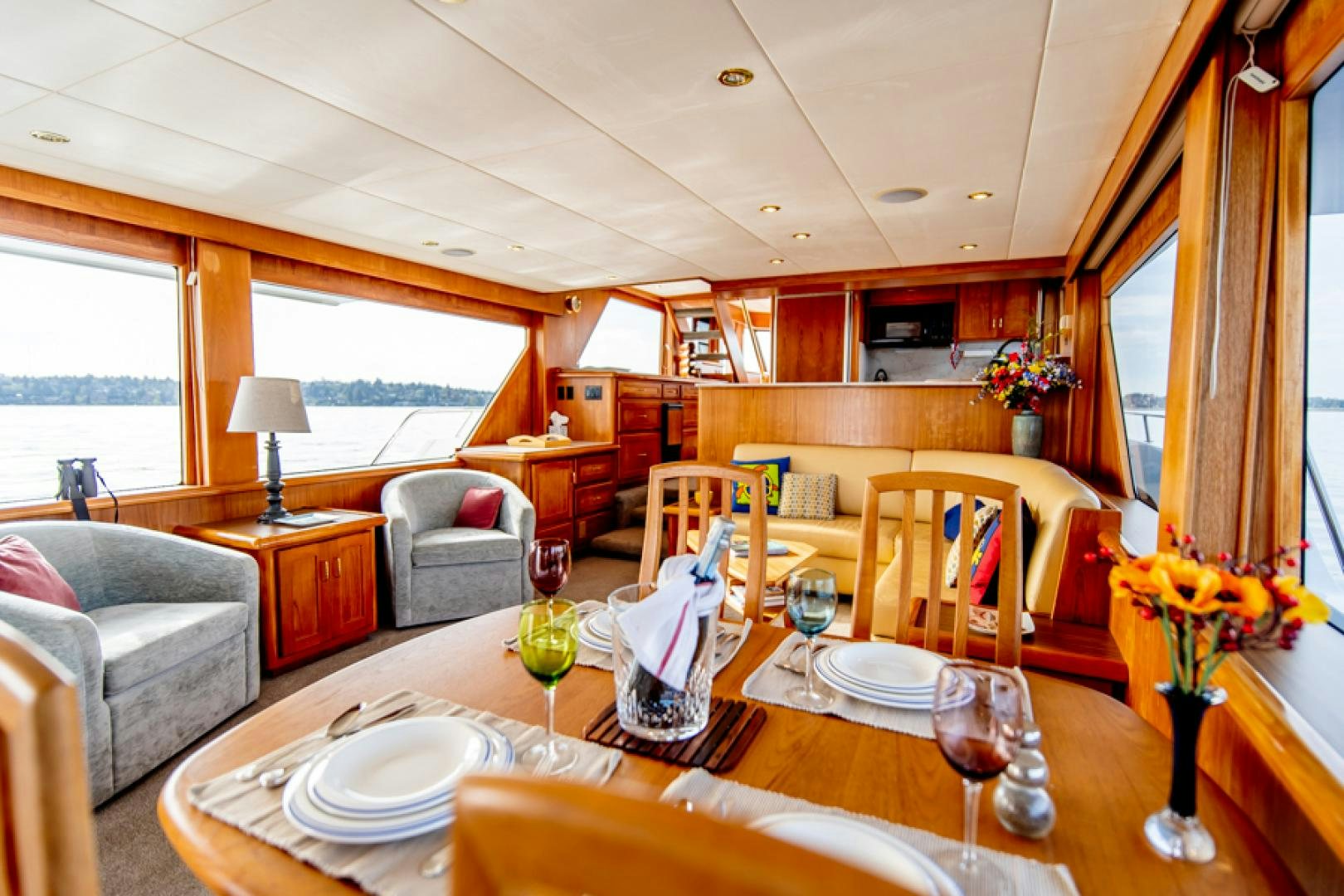 a dining table with wine glasses aboard the happy boat Yacht for Sale