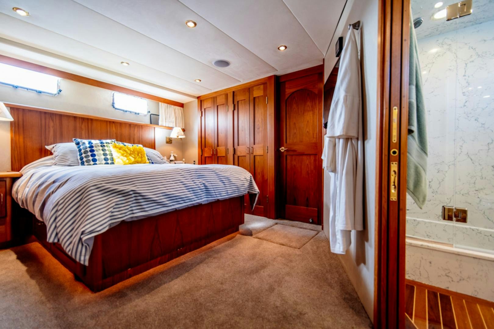 a bed in a room aboard the happy boat Yacht for Sale