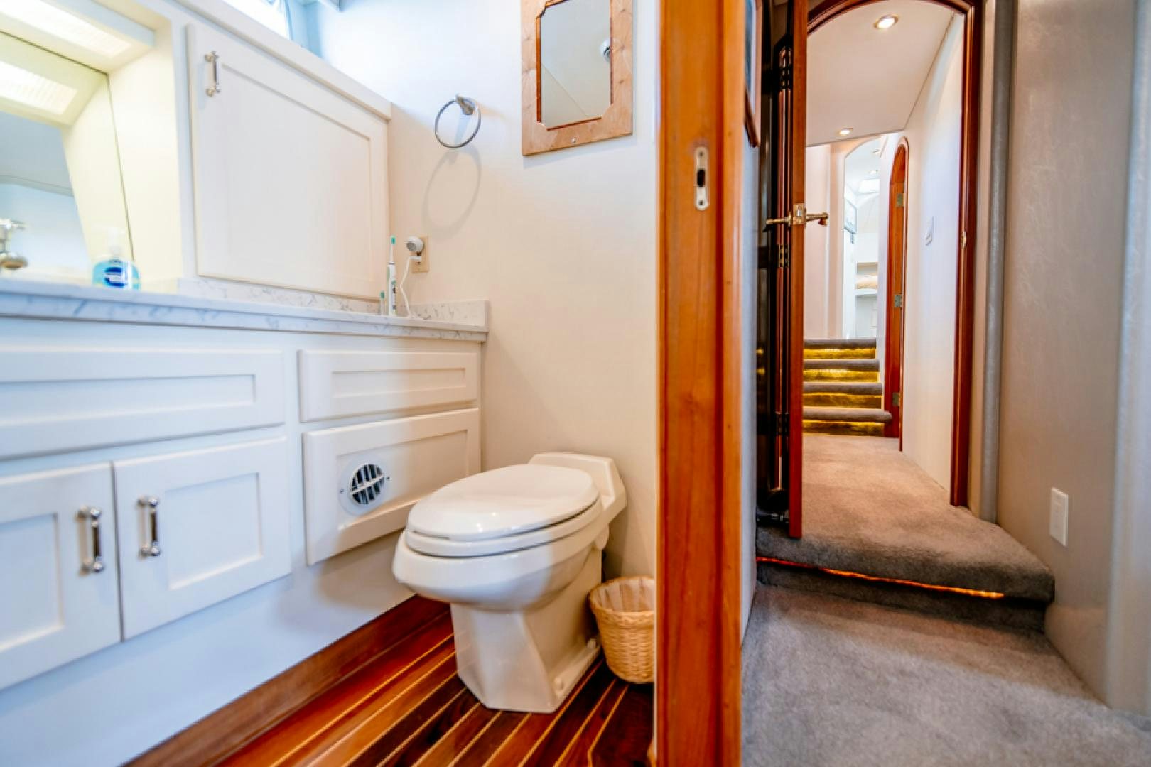 a bathroom with a toilet and a sink aboard the happy boat Yacht for Sale