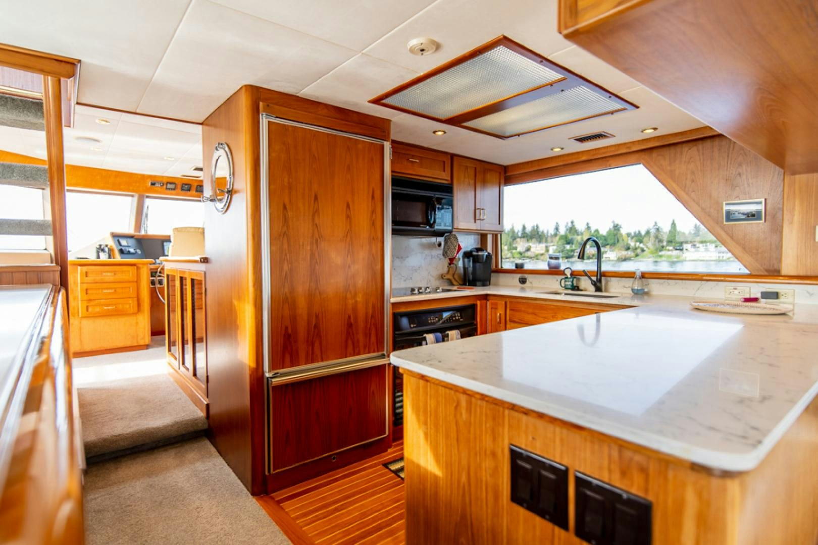 a kitchen with a large island aboard the happy boat Yacht for Sale