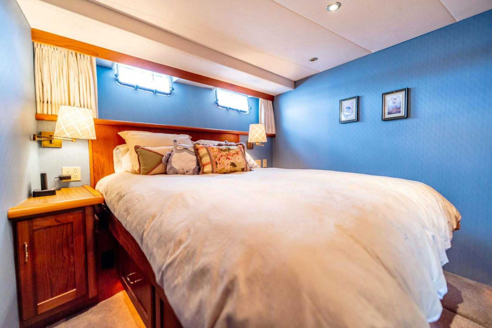a bedroom with a bed and a desk aboard the happy boat Yacht for Sale