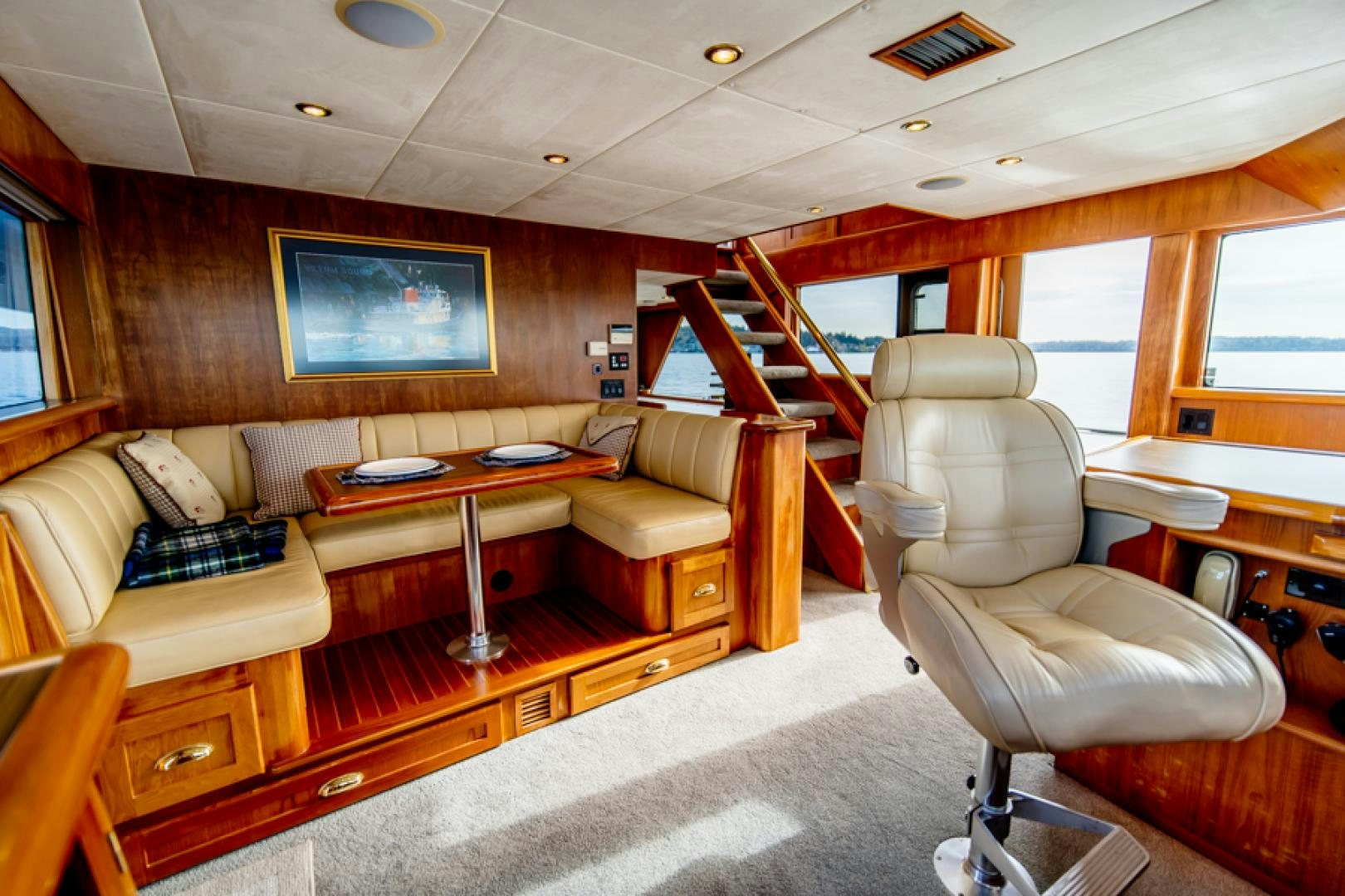 a room with a couch and a table aboard the happy boat Yacht for Sale