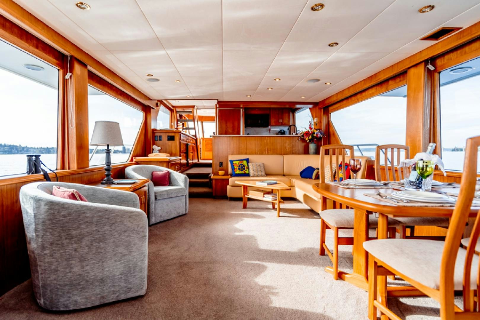 a living room with a dining table aboard the happy boat Yacht for Sale