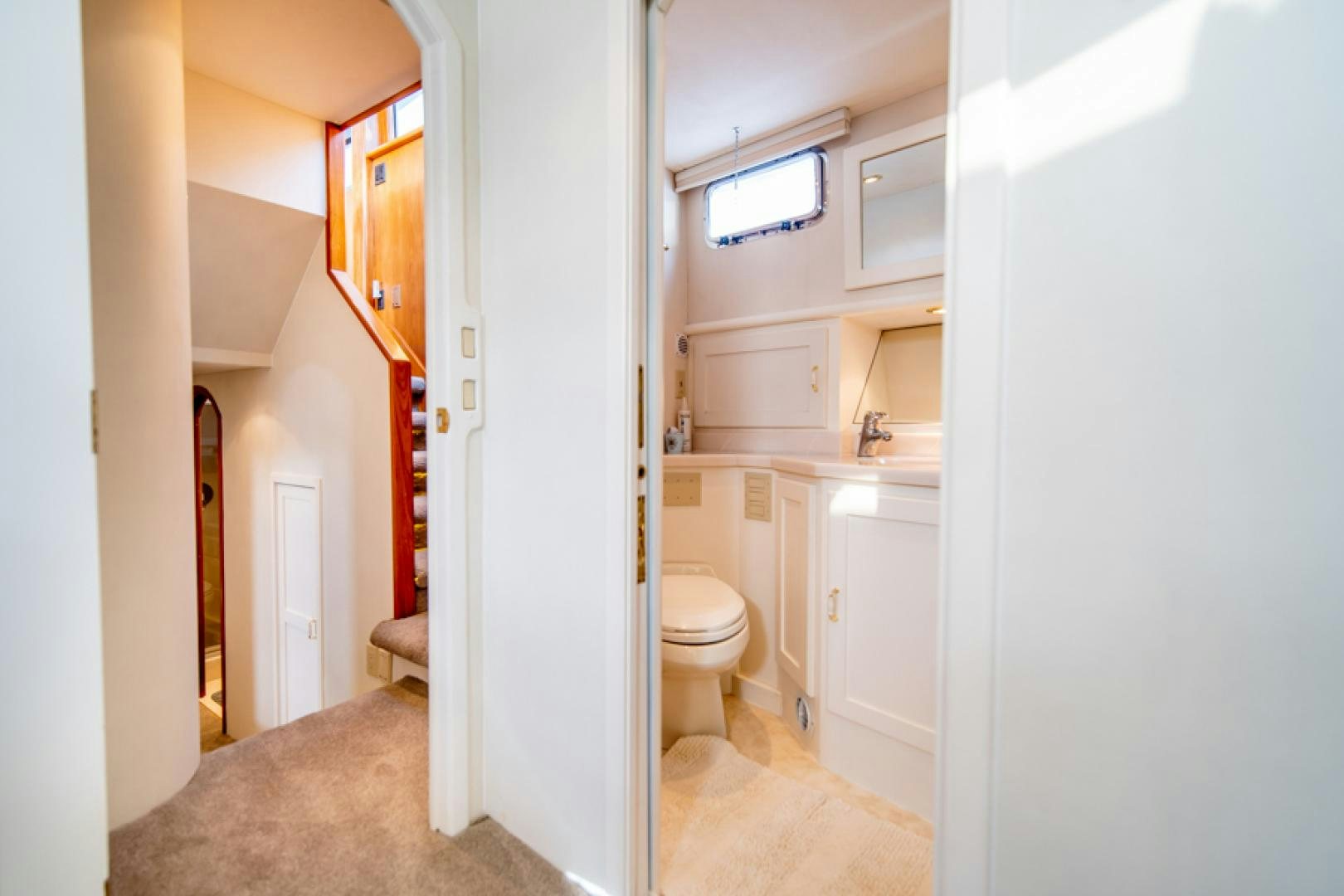 a small bathroom with a toilet aboard the happy boat Yacht for Sale