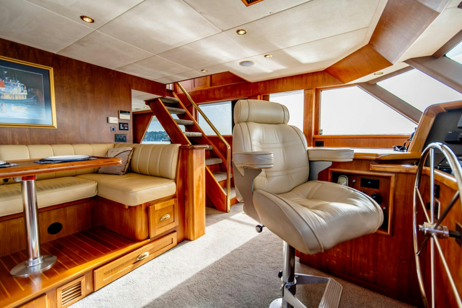 a room with a couch and a table aboard the happy boat Yacht for Sale