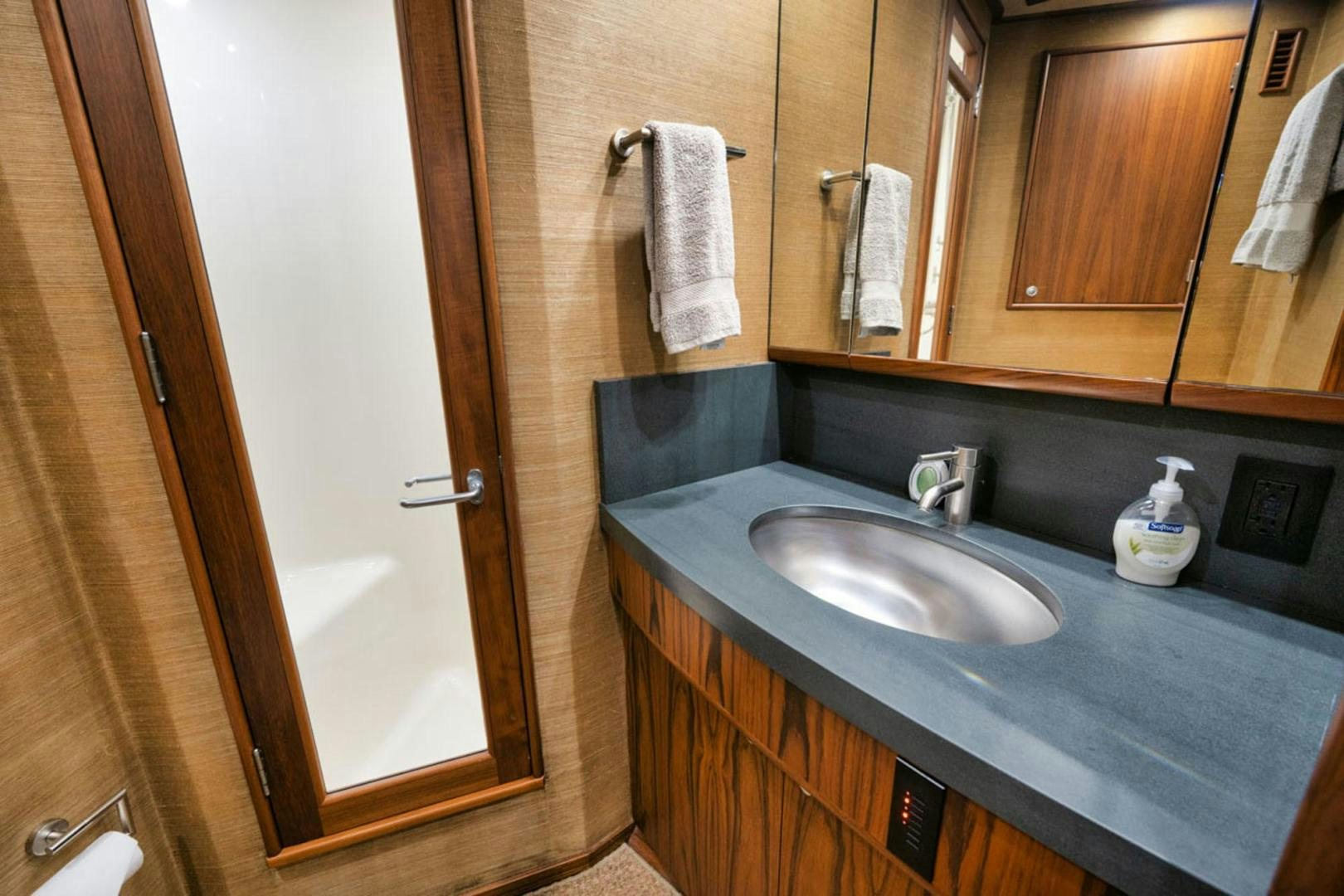 a bathroom with a sink and mirror aboard SIR REEL Yacht for Sale